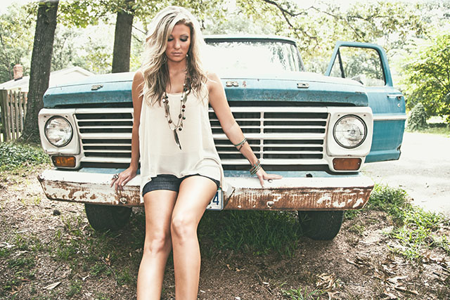 Outdoor portrait in front of a vintage blue pickup truck