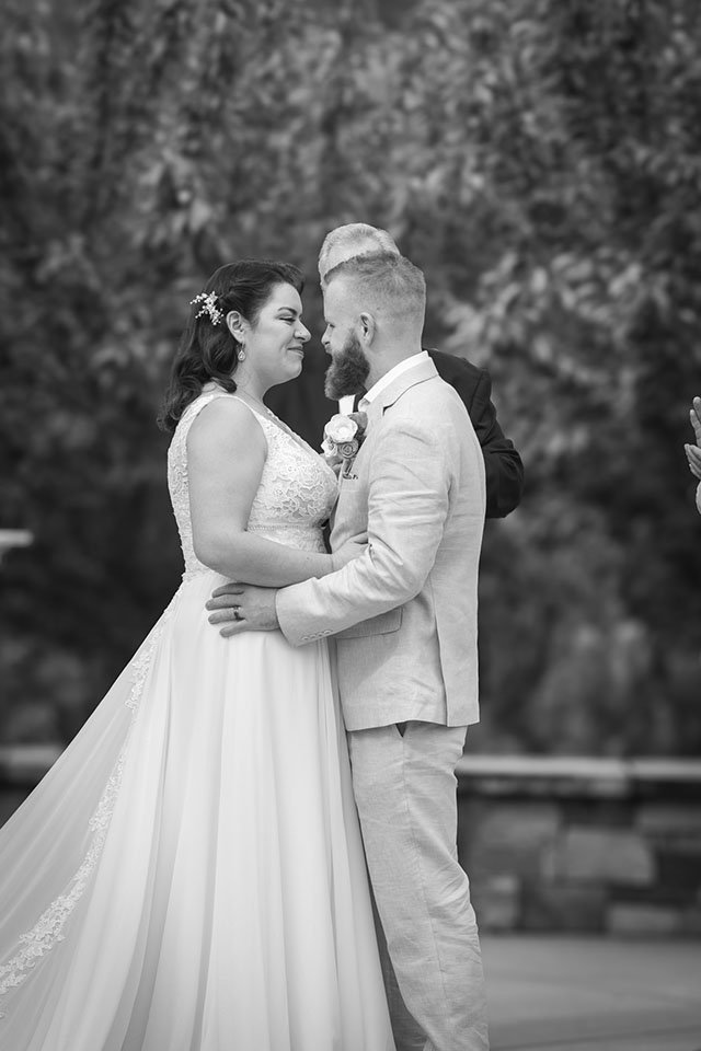 Black-and-white wedding portrait of a couple together outdoors