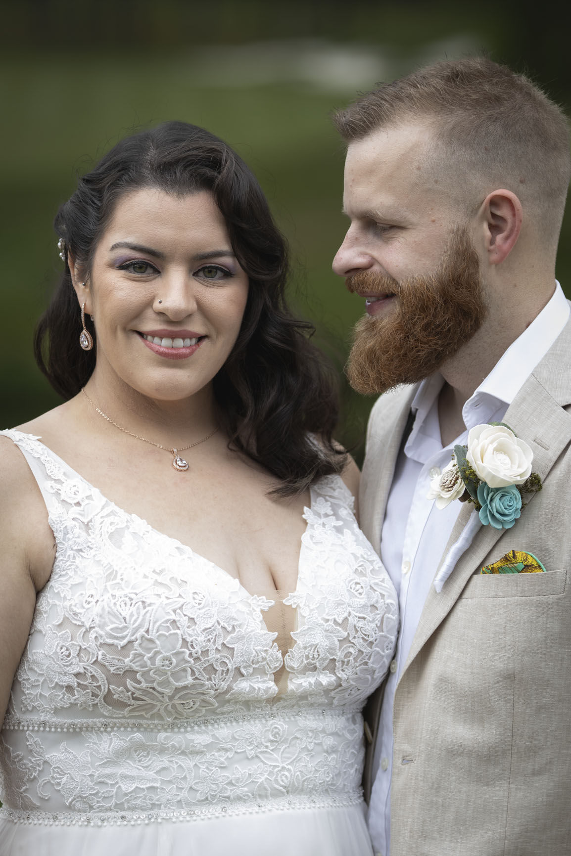 Close wedding portrait of a couple together outdoors
